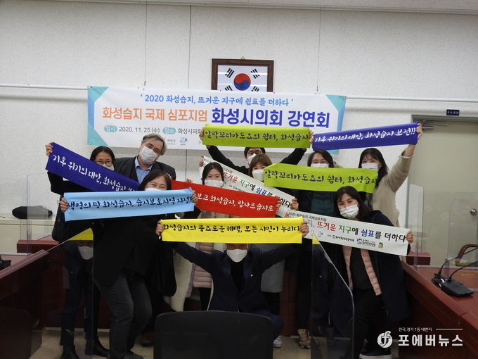 화성시의회는 제198회 화성시의회 본회의 첫날, 의회사무국 대회의실에서 화성시의원 17명이 2020 화성습지 국제심포지엄 행사에 손피켓을 들어 동참을 독려하고 있다. (사진제공=화성시의회)