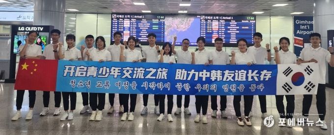 중국 학생들이 28일 입국하면서 한중 청소년 교류 메시지를 펼쳐든 채 기념사진을 찍고 있다.