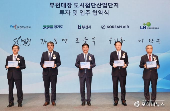조용익 부천시장(가운데)을 비롯한 부천도시공사-경기도-부천시-대한항공-한국토지주택공사(LH) 등 5개 기관 대표자들이 서명을 마친 후 협약서가 담긴 태블릿을 들고 기념 촬영을 하고 있다.